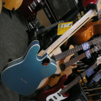 Gorgeous thinline telecaster with short scale neck, metallic blue finish, cream binding on body and neck, humbucking neck pickup, ash body, and more.